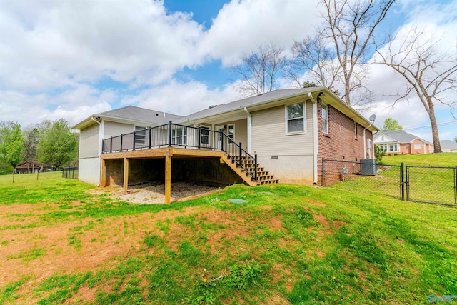 back of property with cooling unit, crawl space, a yard, fence, and stairs