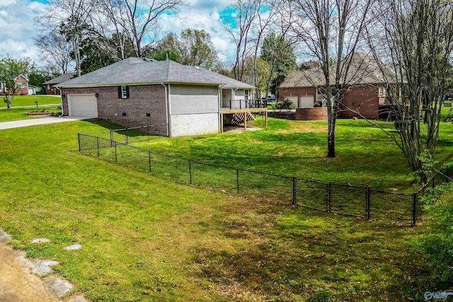 view of yard with concrete driveway, fence, and a garage