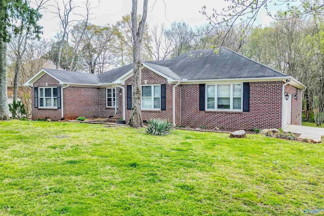 ranch-style house with brick siding, driveway, an attached garage, and a front lawn