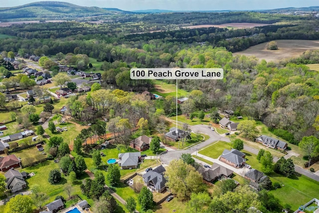 drone / aerial view with a view of trees and a residential view