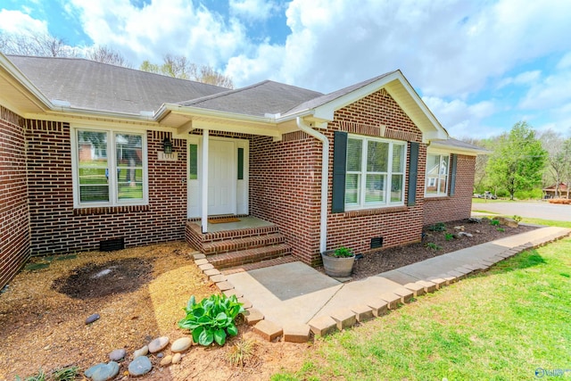 view of front facade with brick siding and crawl space
