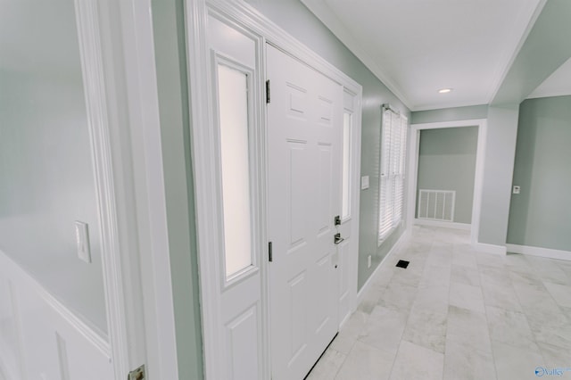 hallway featuring crown molding, marble finish floor, baseboards, and visible vents