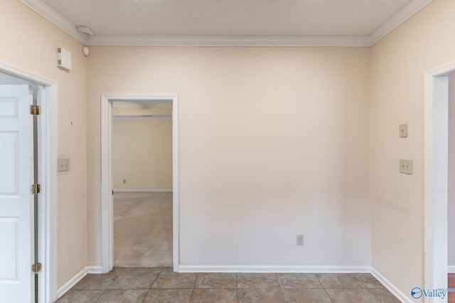 tiled empty room featuring ornamental molding