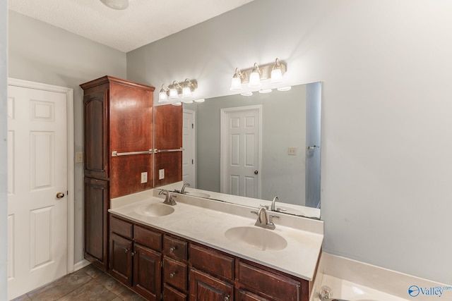 bathroom with vanity and a bath