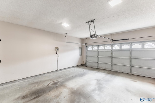 garage with a garage door opener and electric panel
