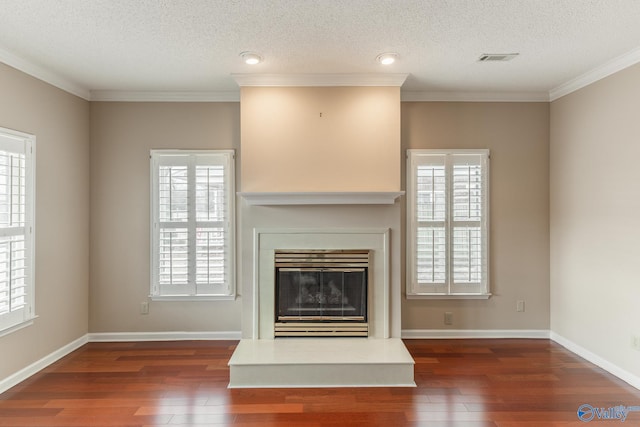 unfurnished living room featuring ornamental molding, dark hardwood / wood-style floors, and a wealth of natural light