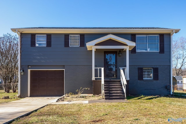 bi-level home featuring a front yard and a garage