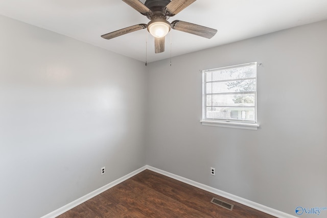 spare room featuring ceiling fan and dark hardwood / wood-style floors