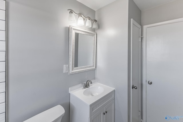 bathroom with toilet and vanity