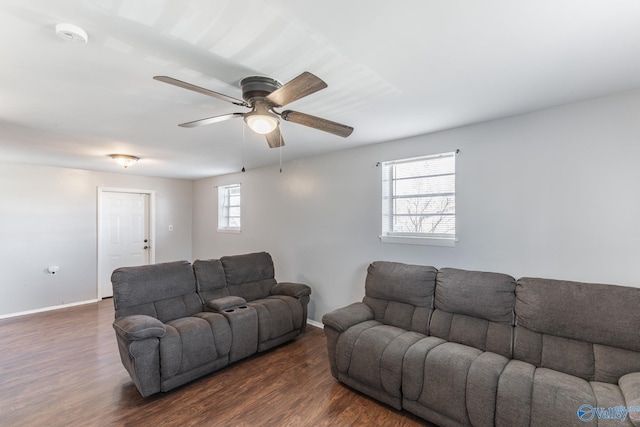 living room featuring ceiling fan and dark hardwood / wood-style flooring