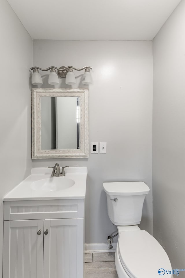 bathroom featuring toilet and vanity