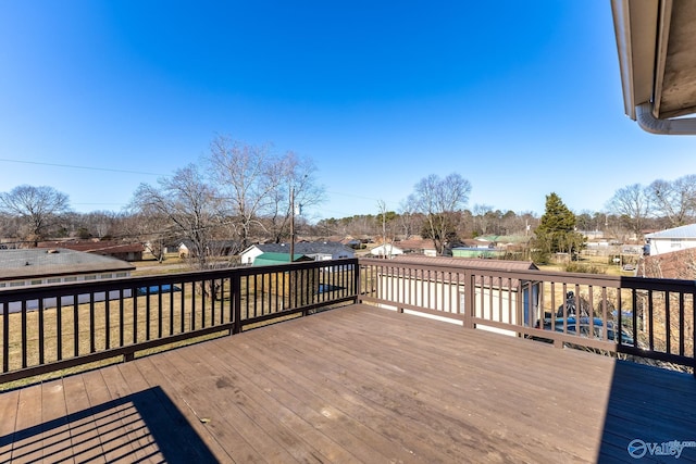 wooden terrace featuring a yard