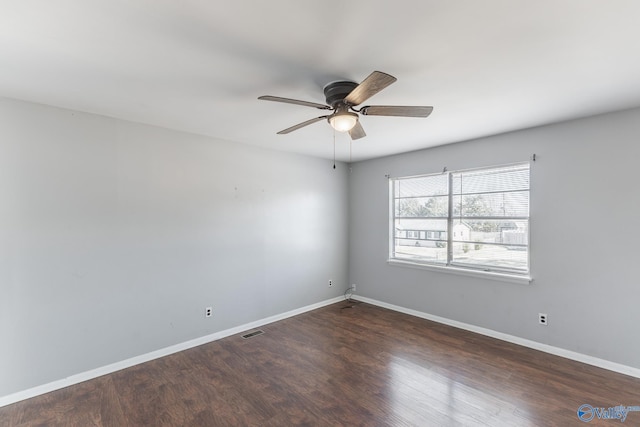 empty room with ceiling fan and dark wood-type flooring