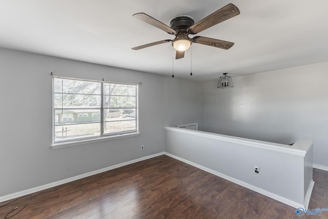 spare room featuring ceiling fan and dark hardwood / wood-style floors