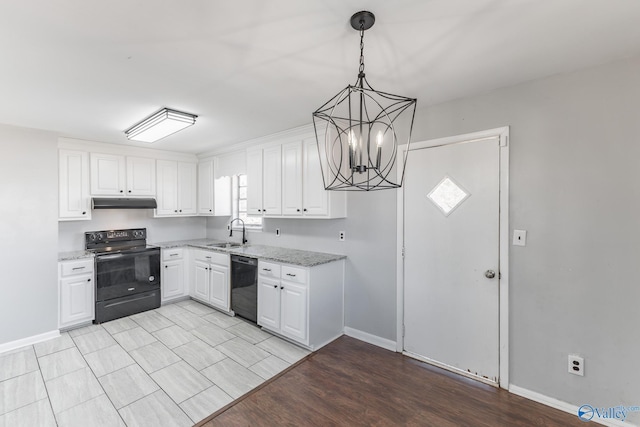 kitchen featuring decorative light fixtures, light stone countertops, black appliances, white cabinets, and sink