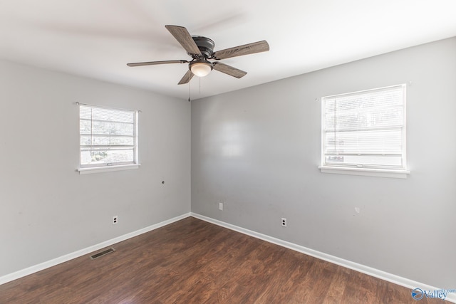 spare room featuring ceiling fan and dark hardwood / wood-style floors