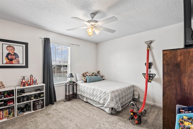 carpeted bedroom with ceiling fan and a textured ceiling