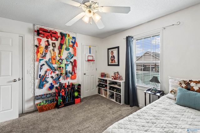 bedroom featuring ceiling fan, a textured ceiling, and carpet flooring