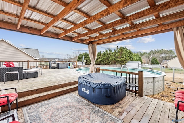 wooden deck with a fenced in pool and a storage unit