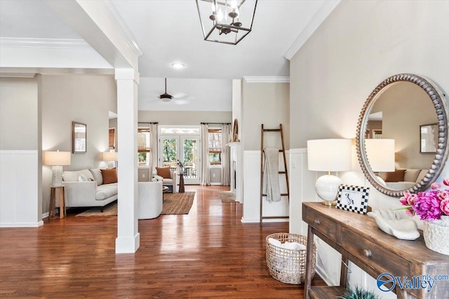 foyer with decorative columns, french doors, dark hardwood / wood-style floors, and ornamental molding