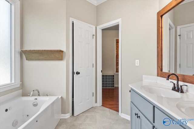 bathroom with a bathing tub, tile patterned flooring, and vanity