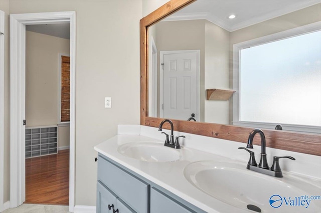 bathroom featuring vanity, wood-type flooring, and ornamental molding