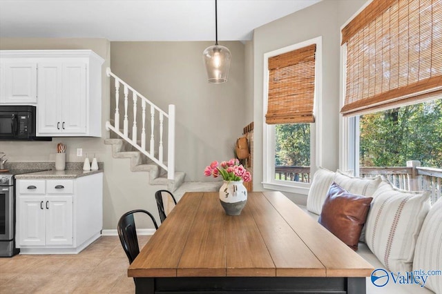 dining space featuring light tile patterned floors