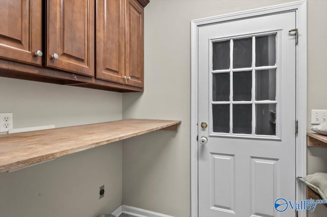 clothes washing area with hookup for an electric dryer and cabinets