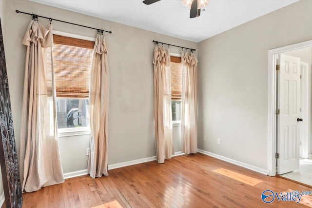 spare room with hardwood / wood-style flooring and ceiling fan