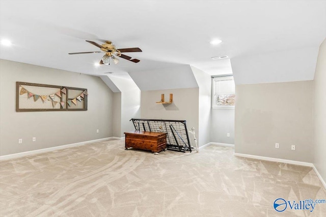 additional living space with light colored carpet, vaulted ceiling, and ceiling fan