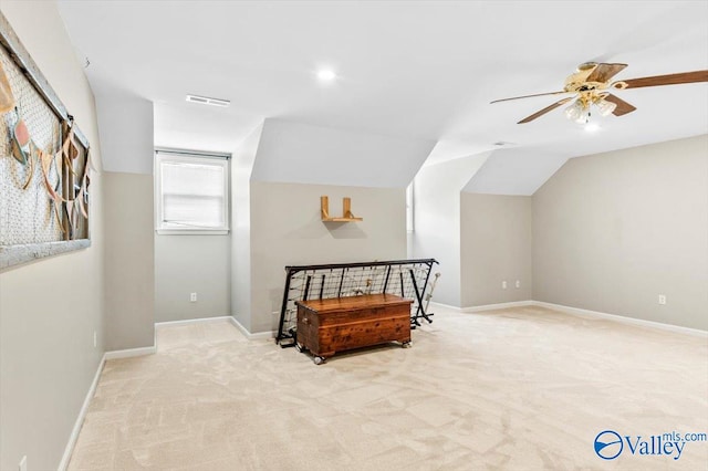 interior space featuring light carpet, ceiling fan, and lofted ceiling