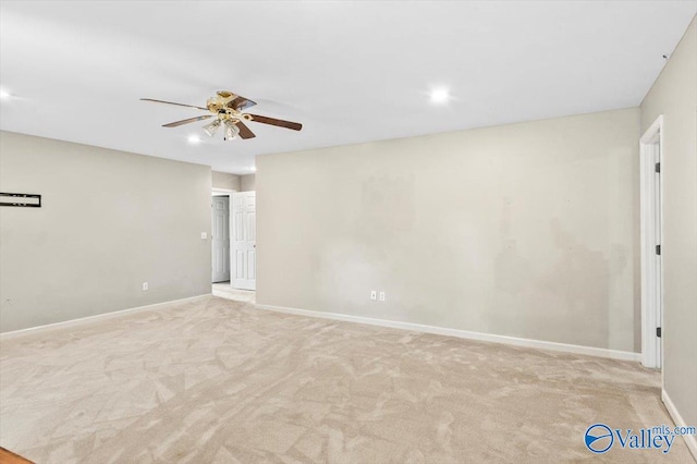 spare room with ceiling fan and light carpet