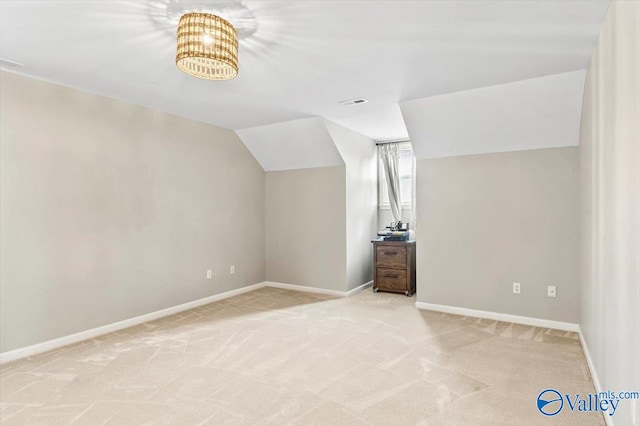 bonus room featuring light colored carpet and vaulted ceiling