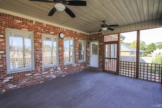 unfurnished sunroom featuring ceiling fan