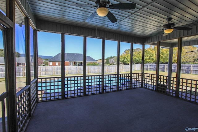 unfurnished sunroom featuring ceiling fan