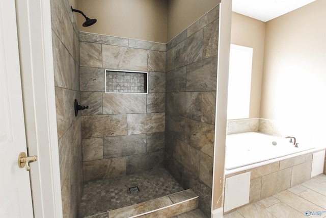 bathroom with separate shower and tub and tile patterned flooring