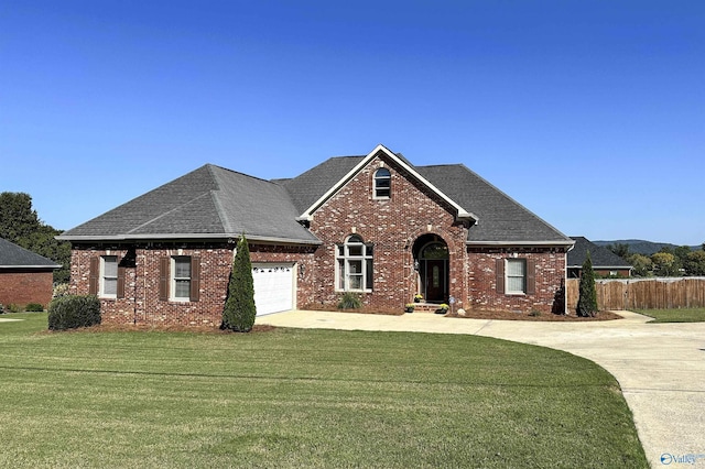 view of front facade with a garage and a front lawn