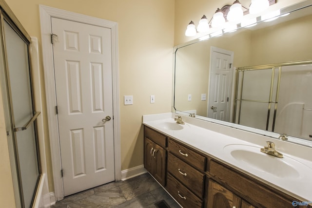 bathroom with vanity and a shower with shower door