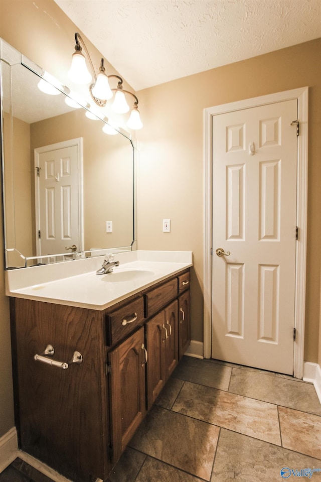 bathroom featuring vanity and a textured ceiling