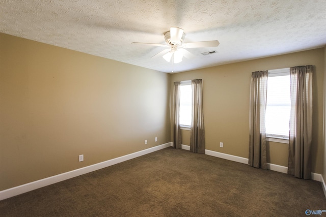 carpeted spare room with ceiling fan and a textured ceiling