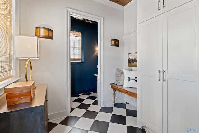 bathroom with crown molding and tile patterned flooring