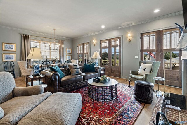 living room with crown molding, french doors, and light hardwood / wood-style flooring