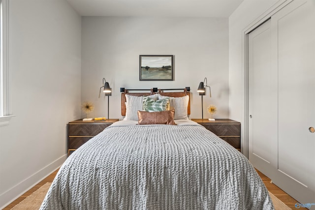 bedroom with light hardwood / wood-style flooring and a closet