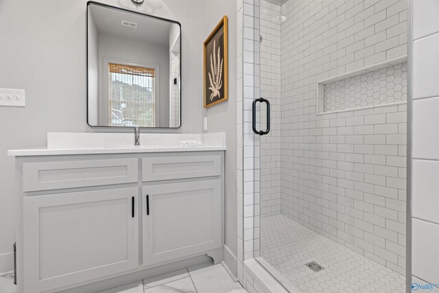 bathroom with vanity, tile patterned flooring, and an enclosed shower