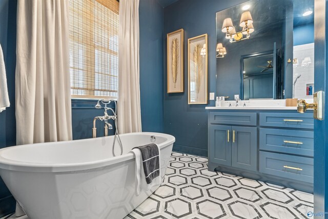 bathroom featuring tile patterned floors, a tub to relax in, and vanity