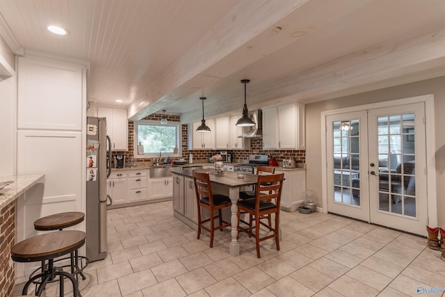 tiled dining room featuring french doors