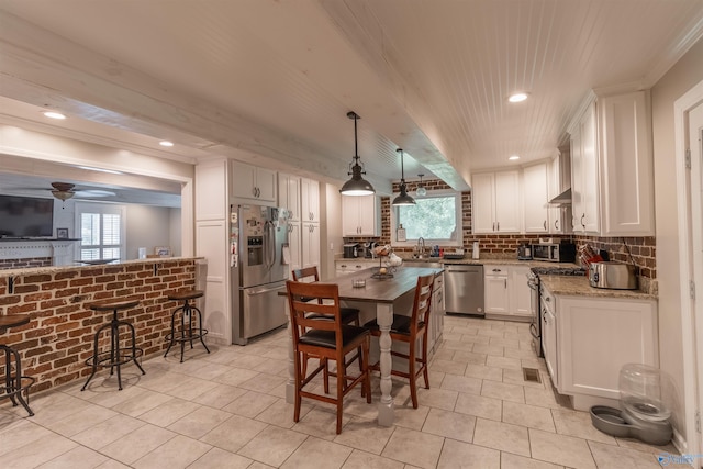 kitchen with tasteful backsplash, visible vents, appliances with stainless steel finishes, white cabinets, and extractor fan