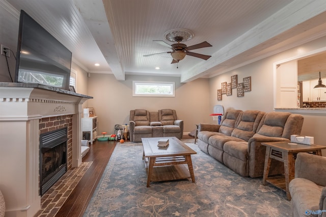 living room with ornamental molding, a brick fireplace, ceiling fan, and dark hardwood / wood-style floors