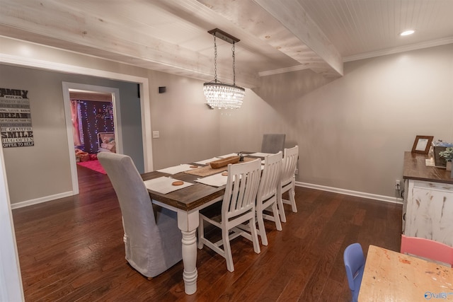 dining room with dark wood-type flooring, crown molding, and baseboards