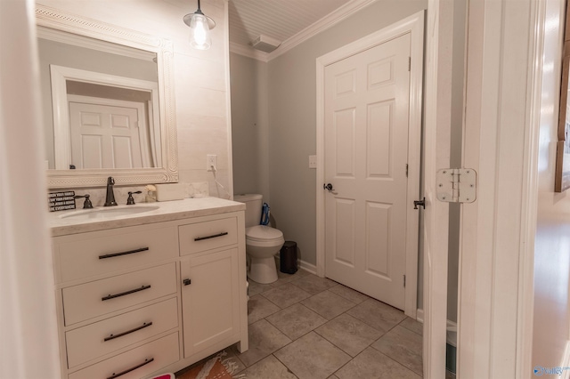 bathroom featuring tile patterned flooring, vanity, toilet, and crown molding